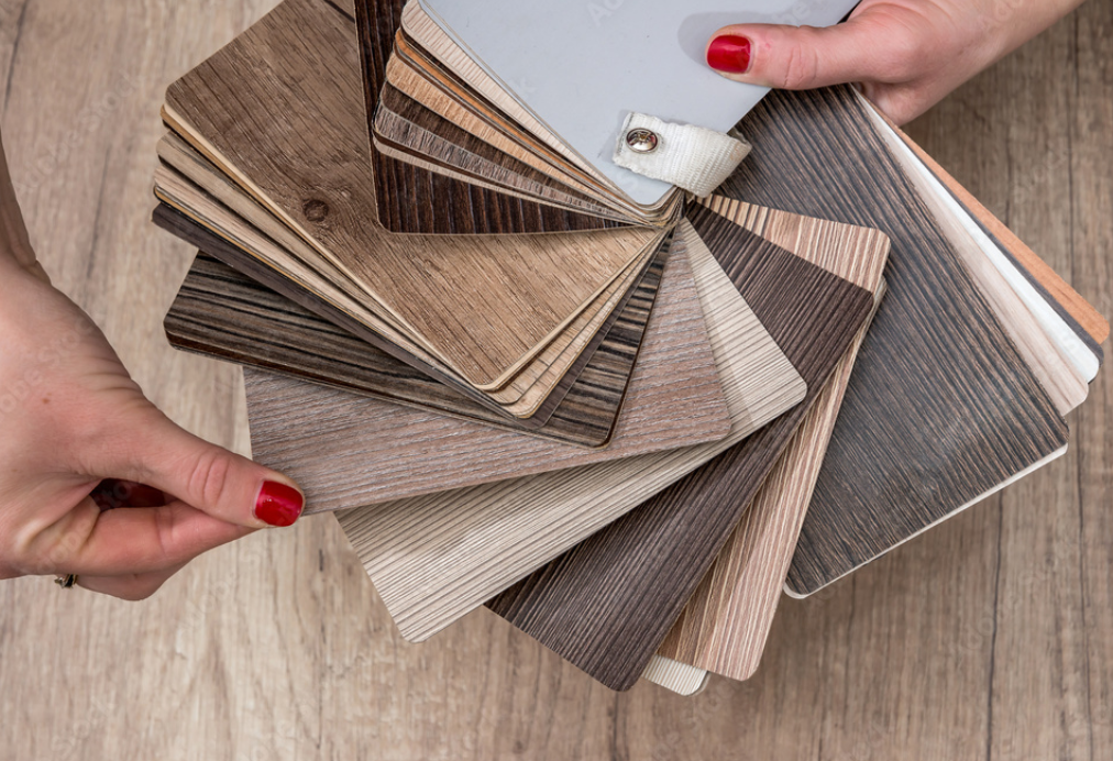 Wide plank waterproof luxury vinyl in warm honey oak tone installed in bright Florida living room, showcasing 2026 flooring trends